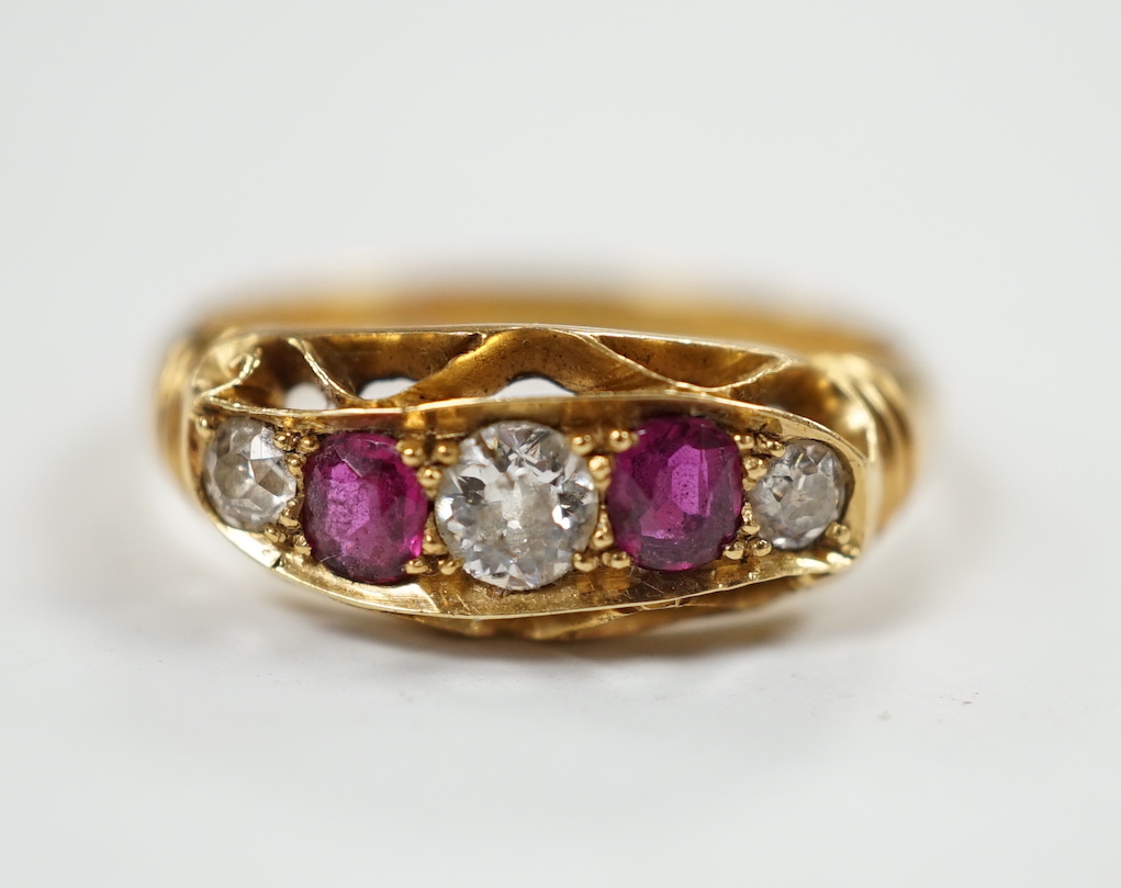 A George V 18ct gold, three stone diamond and two stone ruby set half hoop ring, size N, gross weight 3.8 grams.